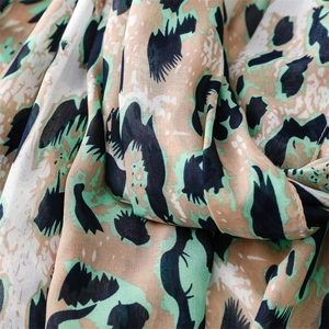 Detailed texture of green leopard print scarf in lightweight, breathable chiffon fabric