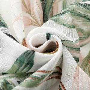 Lightweight tropical palm leaf print scarf in pastel green and pink with fringe