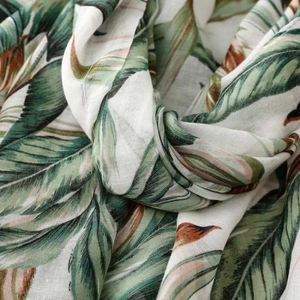 Macro detail of tropical palm leaf pattern on lightweight breathable summer fabric