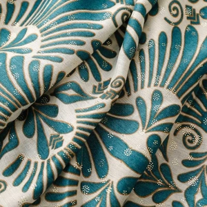 Macro detail of cotton linen scarf with turquoise floral print and gold foil accents