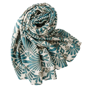 Linen feel scarf with golden floral patterns and frayed edges in lake blue and teal