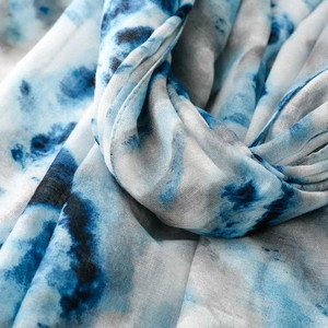 Detailed close-up of blue tie-dye printed voile scarf with visible weave and natural folds