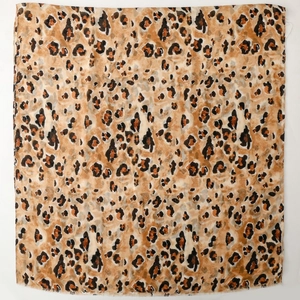 Detailed close-up of leopard print cotton-linen fabric with subtle gold foil stone patterns