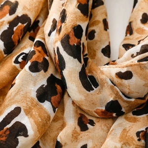 Close-up of leopard print scarf showing detailed fabric texture and fine hemmed edges