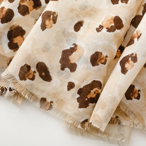 Detailed macro view of leopard print cotton linen scarf with soft frayed edge texture
