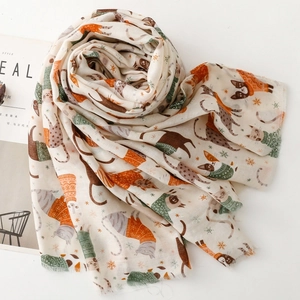 Detail shot of soft beige scarf featuring cute cat illustrations and colorful patterns
