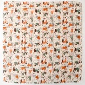Detail of cat park print on cream scarf showing cute cats and orange snowflakes