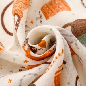 Detail of soft cotton gauze scarf featuring cat patterns and fine woven texture
