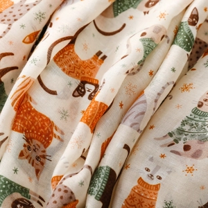 Close-up of soft cotton scarf featuring cute cat patterns and snowflake prints