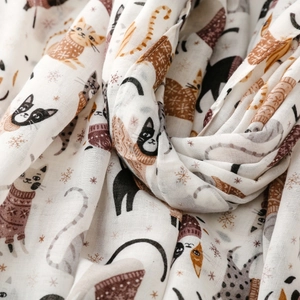 Close-up of soft cat park print fabric with winter snowflake details and texture