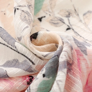 Macro view of soft linen texture with pink floral pattern and breathable fabric detail