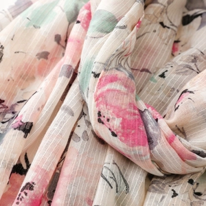 Detail of floral linen texture scarf with pink flower prints and slub yarn fabric weave
