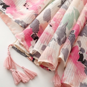 Close-up of pink floral scarf with bamboo yarn texture and delicate tassel details