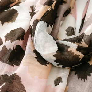 Detail of pink and khaki leopard print scarf showing soft texture and tassel weave