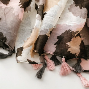Close-up of lightweight leopard print scarf with soft tassels and breathable fabric