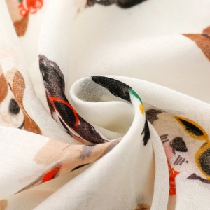 Close-up of soft cotton gauze fabric with colorful cartoon sunglasses dog prints