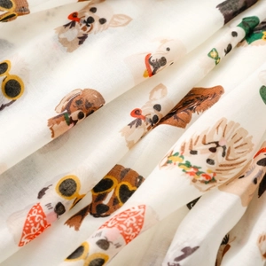 Detailed view of lightweight fabric featuring playful cartoon dogs with sunglasses print