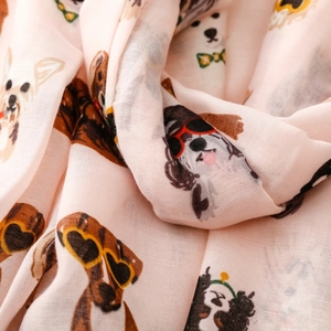 Close-up of light pink scarf featuring cute dogs in sunglasses with soft fabric texture