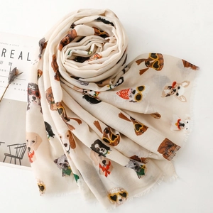 Detail of cream long scarf with cartoon dogs wearing sunglasses and mini tassels