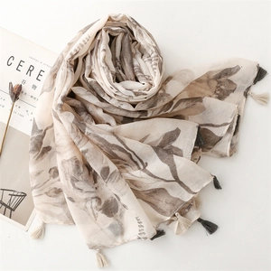 Detail of floral printed scarf with fringe tassels and delicate leaf patterns