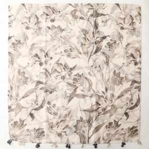 Lightweight cotton-linen feel scarf featuring grey floral prints and fringe tassels