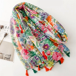 Macro detail of floral pattern chiffon scarf with vibrant tassels and artistic drape