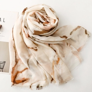 Detail of artistic ink wash butterfly print scarf with fine fringe edges and soft texture