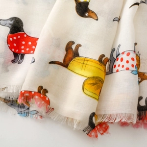 Detail of dachshund dog print on soft white scarf with delicate frayed edges texture