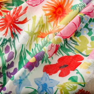 Macro detail of colorful wildflower print on lightweight breathable voile fabric shawl