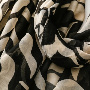 Close-up of the breathable cotton-linen feel fabric with abstract black and beige patterns
