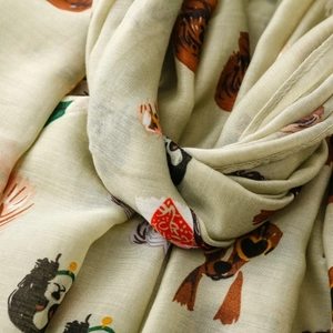 Detailed close-up of lightweight cotton scarf featuring cute cartoon dog patterns
