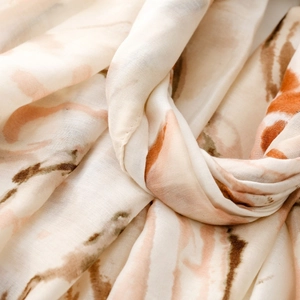 Detail shot of soft ink butterfly print scarf with delicate fabric folds and smooth texture