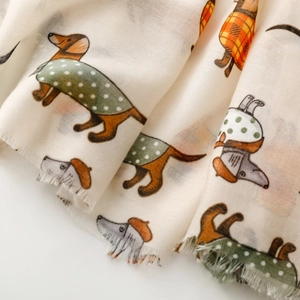 Detailed macro view of beige cotton dachshund dog print scarf with natural frayed edges