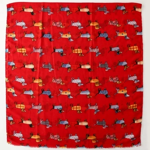 Detail of red dachshund print scarf featuring cute dogs and fringe edge texture