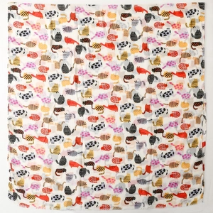 Detail of colorful cartoon cat print on soft silk scarf with fringe edge details