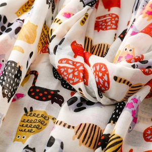 Detailed macro view showing the soft fabric texture and colorful cartoon cat print