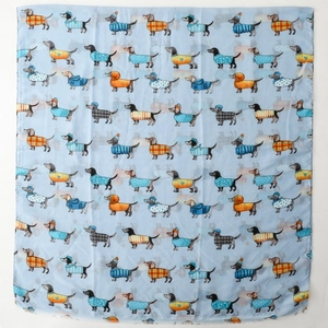 Detailed view of light blue dachshund print scarf featuring dogs in colorful sweaters