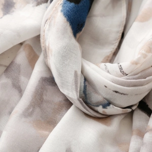 Macro detail of abstract ink print scarf showing fabric texture and fine stitching