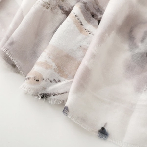 Detail of artistic ink painting printed scarf showing soft cotton texture and fringed edges