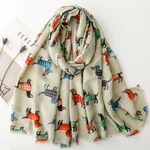 Lightweight scarf with colorful cartoon dachshund dog print and fringed edges on white base
