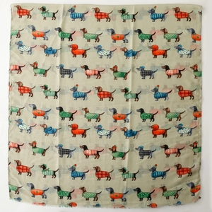 Close-up of dachshund dog print pattern on soft green cotton satin scarf