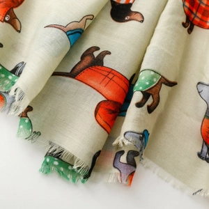Detail of dachshund print scarf showing woven texture and soft frayed fringe edges