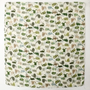 Flat lay of colorful cartoon cat prints on a soft silk scarf with vibrant floral patterns