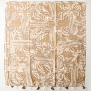 Detail of minimalist beige cotton linen scarf with white geometric lines and fringe edges
