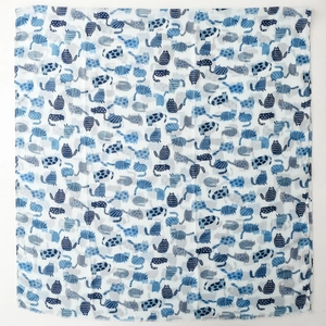 Detail view of blue cartoon cat prints on white cotton scarf with frayed edges