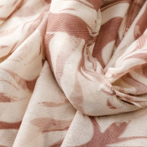 Close-up of elegant cotton-linen scarf with soft wavy pattern and natural fabric texture