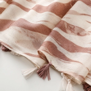 Close-up of elegant zebra pattern scarf showing soft fabric texture and dual-color tassels