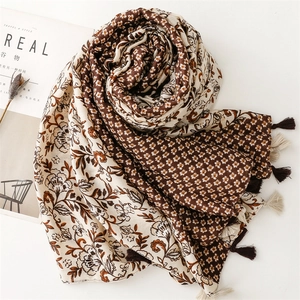 Detailed view of floral cotton linen scarf with handmade tassel fringe and retro patterns
