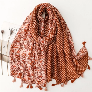 Reddish-brown and cream scarf with floral patterns and handmade tassels