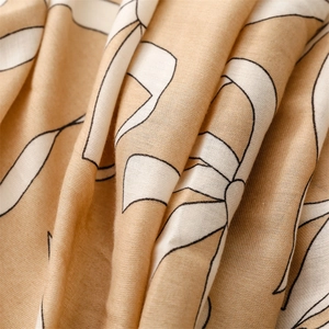 Detailed macro view of beige linen-feel fabric with white abstract floral patterns